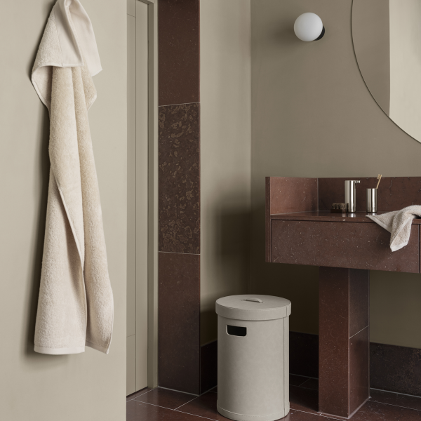 Elegant bathroom design featuring marble accents, a modern mirror, and minimalistic decor.