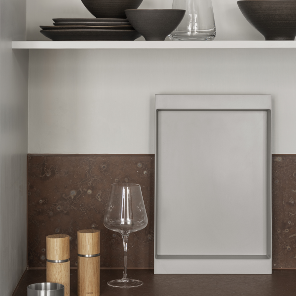 Modern kitchen shelf with elegant tableware and decorative glassware arrangement.