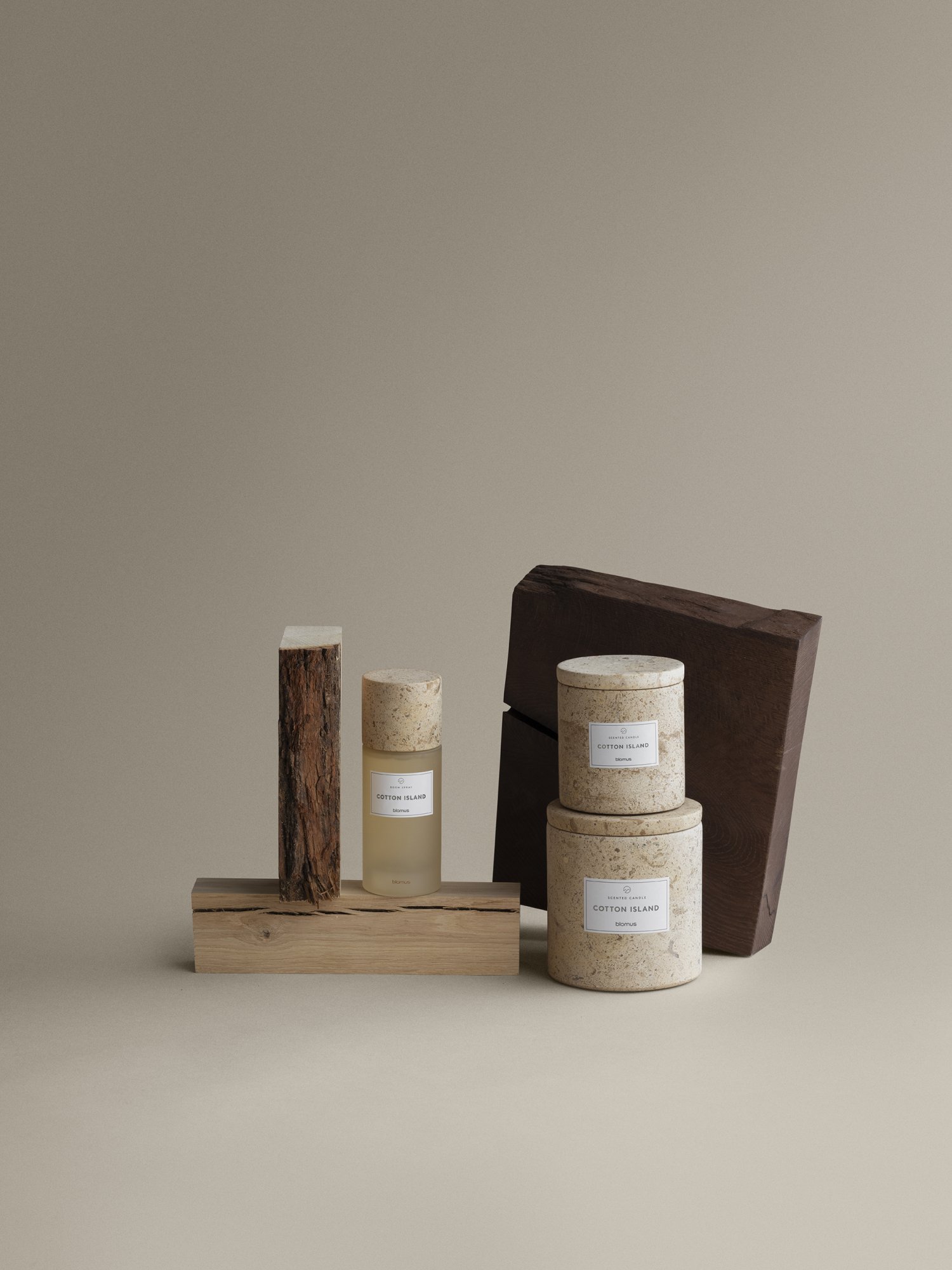 Elegant skincare products displayed on natural wooden elements against a neutral background.