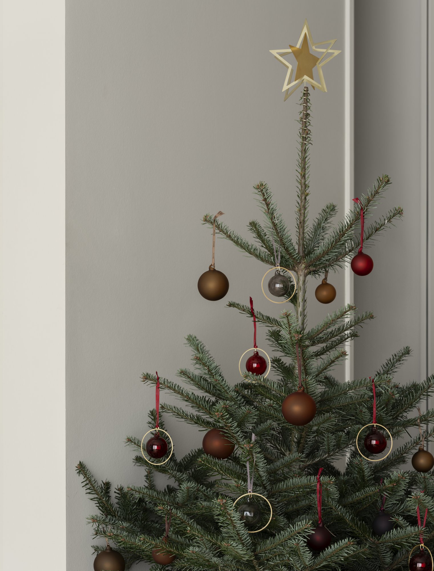 Beautifully decorated Christmas tree with ornaments and a star on top.