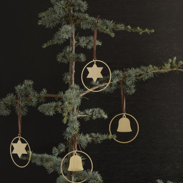 Elegant golden ornaments hanging from a Christmas tree branch against a dark background.