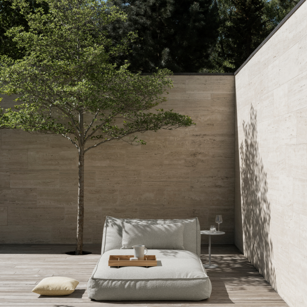 Serene outdoor seating area with a tree, neutral tones, and minimalist design.